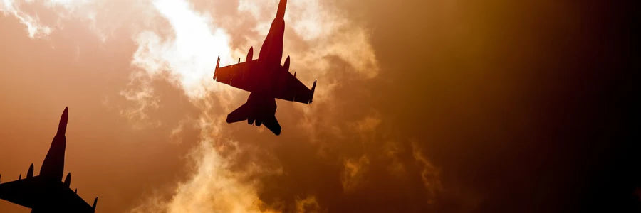 The image shows two fighter jets in the a bright, fiery sky, representing the kinds of professions Covert Threads' fire retardant apparel is built for.