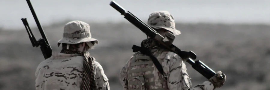 The image shows two military members on patrol in desert uniforms, demonstrating Covert Thread's ability to make tough socks for arid, hot, desert climates.